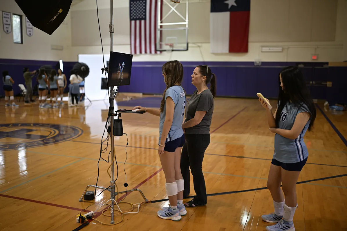 Volleyball athletes reviewing a photo at the on-site media-day setup