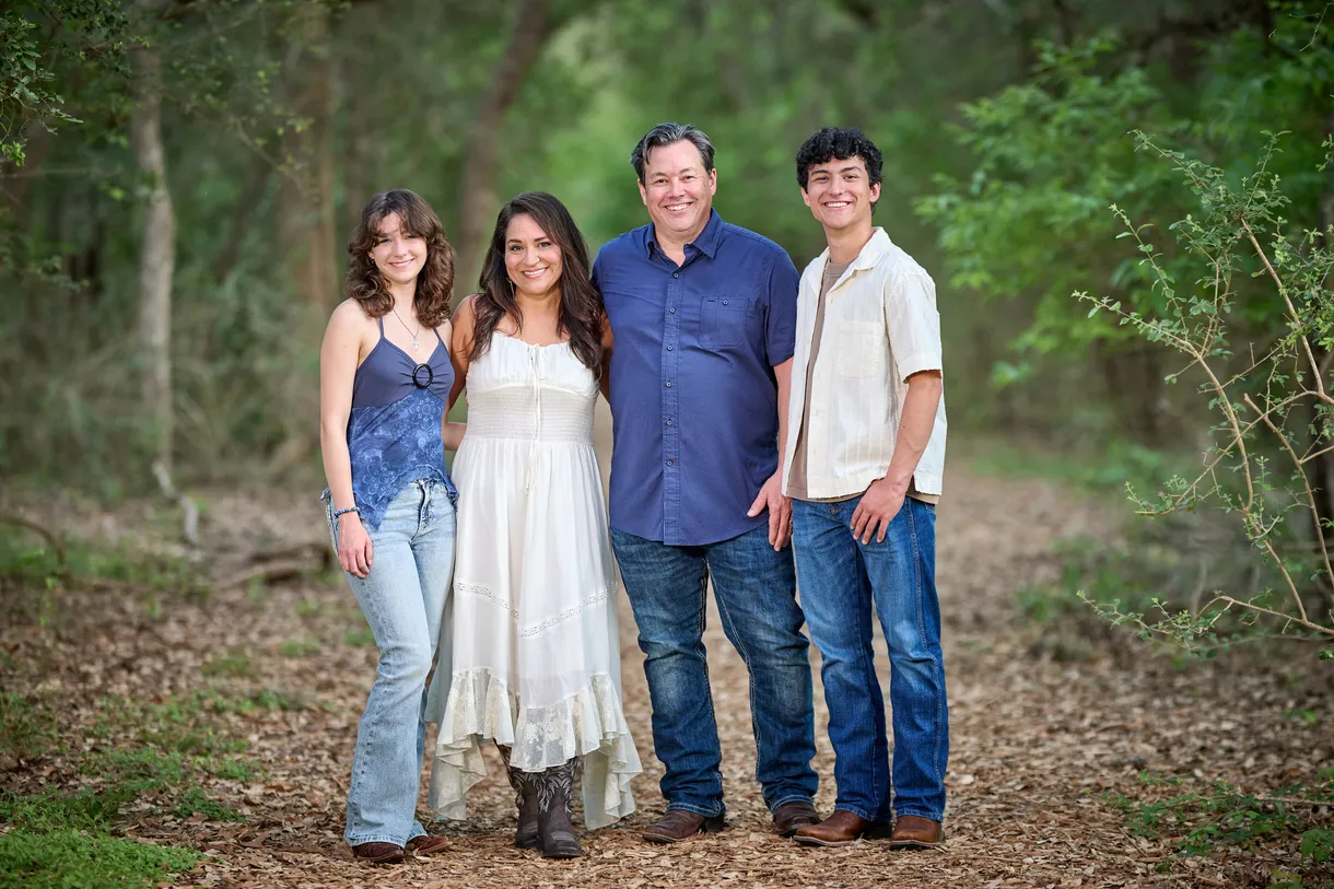 Family of four photographed in the woods
